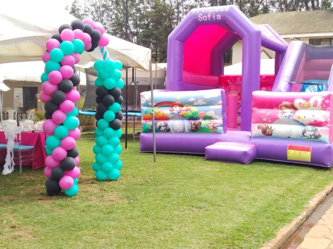 Colourful kids party setup with bouncy castle, themed decorations, and balloon modeling in Nairobi