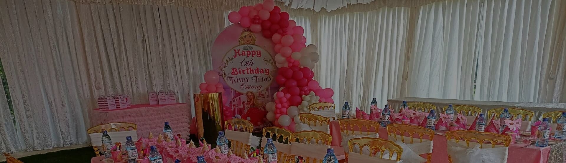 Themed birthday party setup in Nairobi with balloon backdrop, themed cake table and kids seating